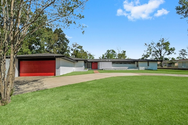 ranch-style home featuring a garage and a front yard