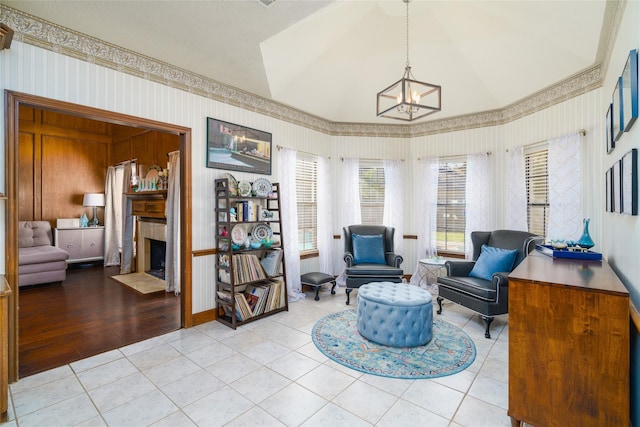 sitting room featuring a notable chandelier, vaulted ceiling, and light tile patterned floors