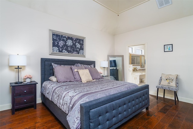 bedroom featuring dark hardwood / wood-style floors and ensuite bath