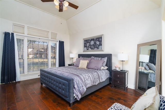 bedroom with ceiling fan, dark hardwood / wood-style floors, and vaulted ceiling