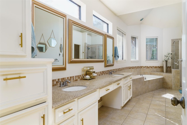 bathroom with tile patterned flooring, vanity, lofted ceiling, and plus walk in shower