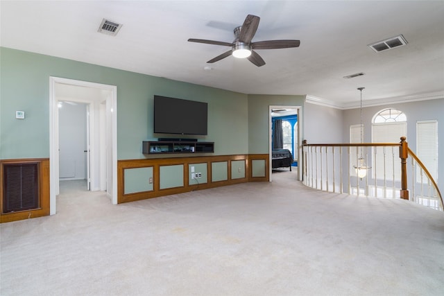 unfurnished living room with ceiling fan, light colored carpet, and plenty of natural light