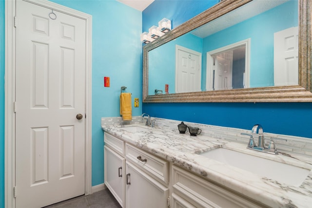 bathroom featuring tile patterned flooring and vanity