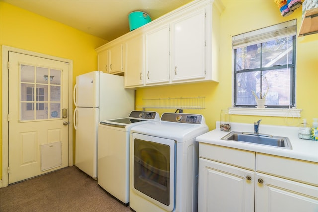 washroom featuring cabinets, washer and clothes dryer, sink, and dark colored carpet