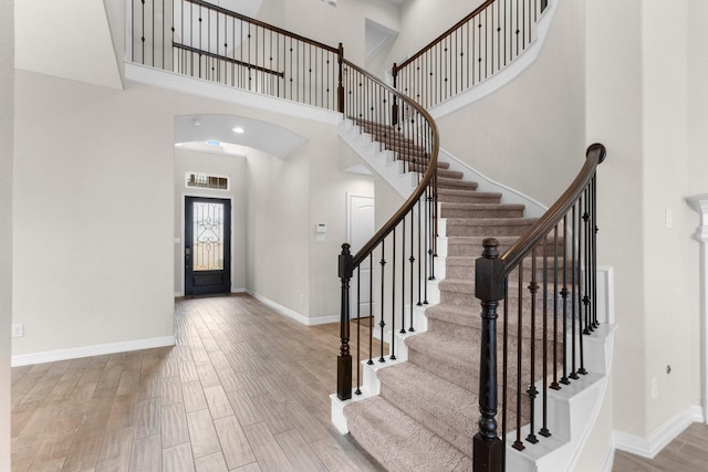 entryway with light hardwood / wood-style floors and a high ceiling