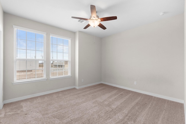 carpeted empty room featuring ceiling fan