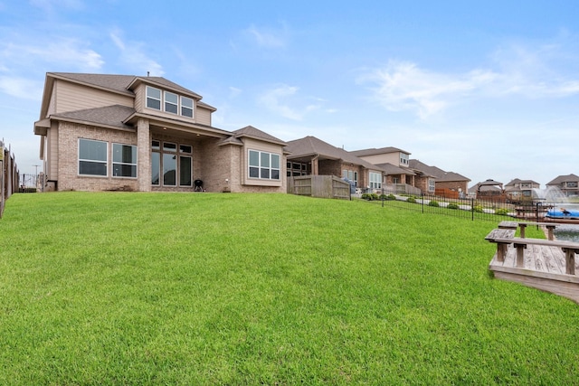 back of house with a lawn