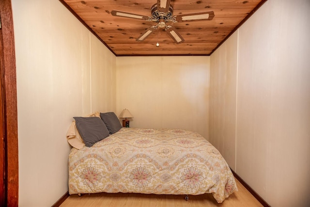 bedroom with ceiling fan, ornamental molding, hardwood / wood-style floors, and wooden ceiling