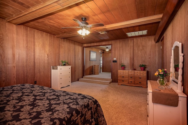 carpeted bedroom with wooden ceiling and wood walls