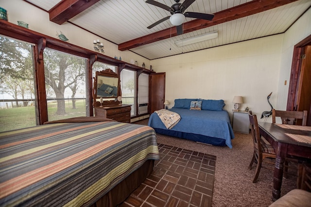 bedroom with ceiling fan and beam ceiling