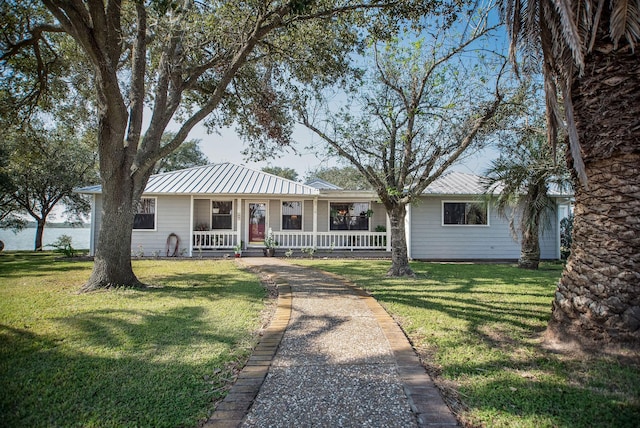 ranch-style house with a front lawn and covered porch