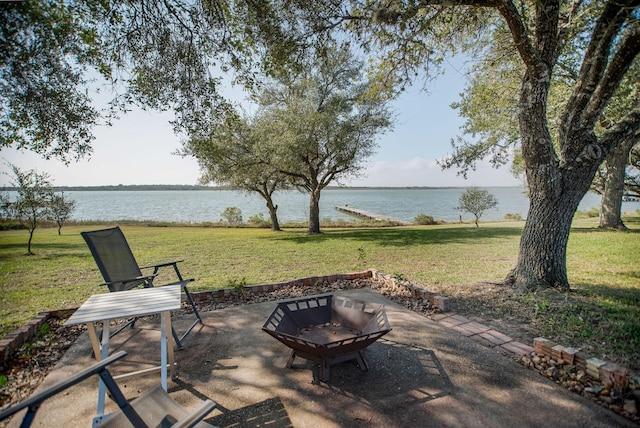 view of patio featuring a water view and an outdoor fire pit