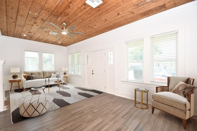 living area featuring hardwood / wood-style flooring, ceiling fan, crown molding, and wooden ceiling