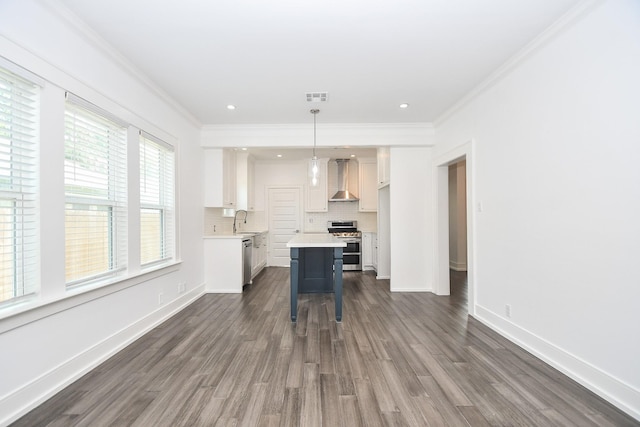 kitchen with pendant lighting, sink, white cabinetry, and appliances with stainless steel finishes