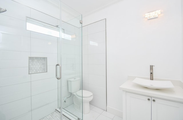 bathroom featuring walk in shower, toilet, crown molding, vanity, and tile patterned flooring