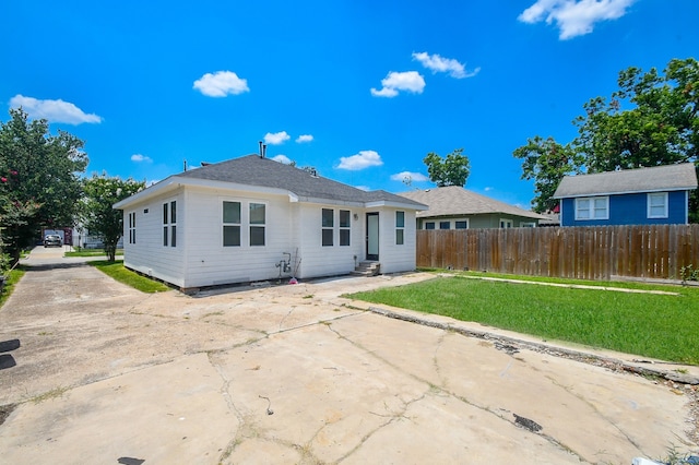 rear view of house with a lawn