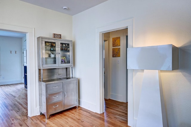 hall with light hardwood / wood-style flooring