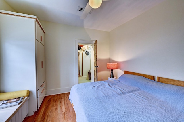 bedroom with light hardwood / wood-style floors and ceiling fan