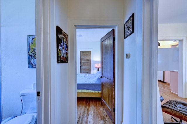 hallway with light hardwood / wood-style floors