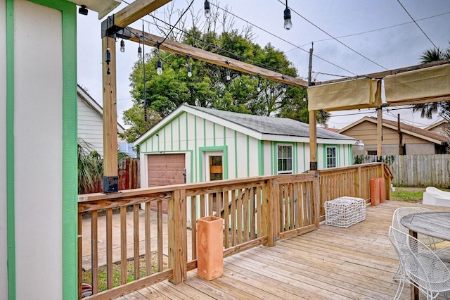 wooden terrace with a garage and an outdoor structure