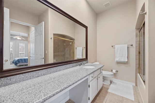 full bathroom featuring enclosed tub / shower combo, ceiling fan, tile patterned flooring, vanity, and toilet