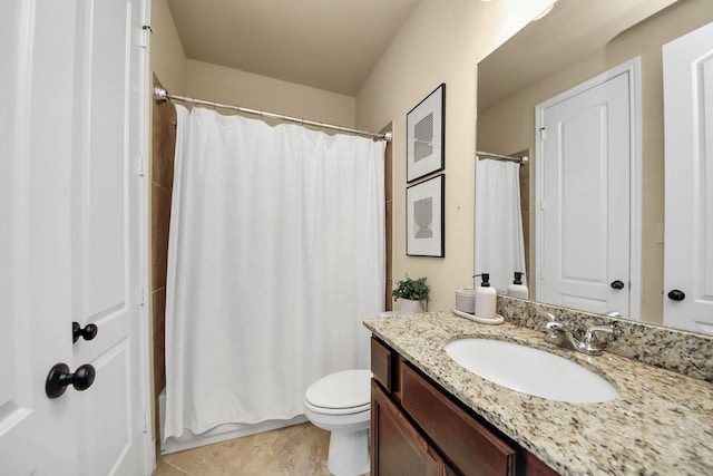 bathroom featuring vanity, tile patterned flooring, toilet, and walk in shower