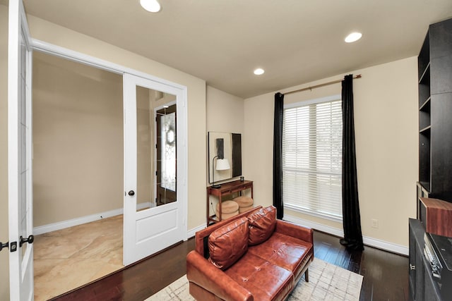 sitting room with french doors and dark wood-type flooring