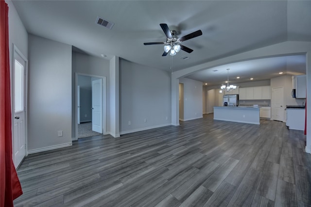 unfurnished living room with wood-type flooring and ceiling fan with notable chandelier