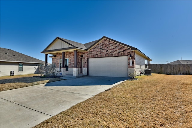 ranch-style home featuring central AC, a garage, and a front lawn