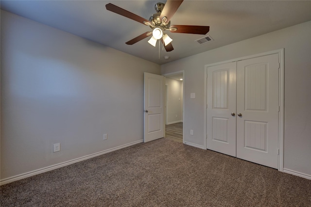 unfurnished bedroom with ceiling fan, a closet, and carpet