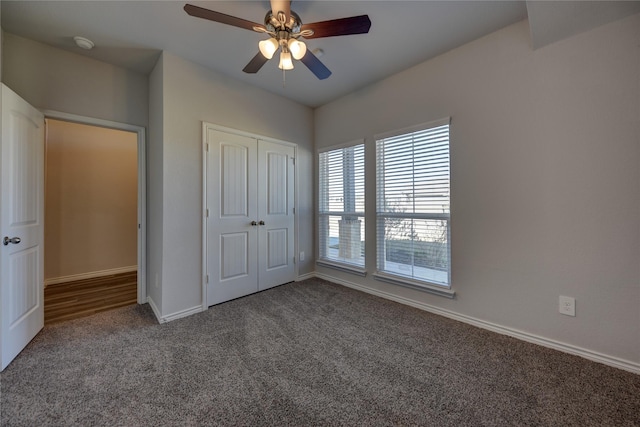 unfurnished bedroom featuring a closet, ceiling fan, and carpet flooring