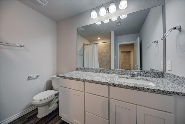 bathroom with hardwood / wood-style flooring, vanity, toilet, and curtained shower