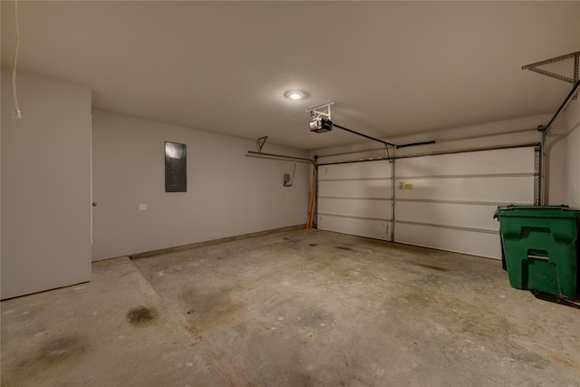 garage with a garage door opener and electric panel