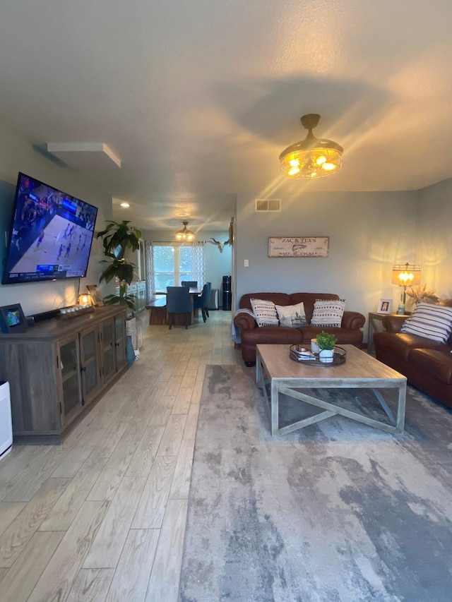 living room with hardwood / wood-style flooring and ceiling fan