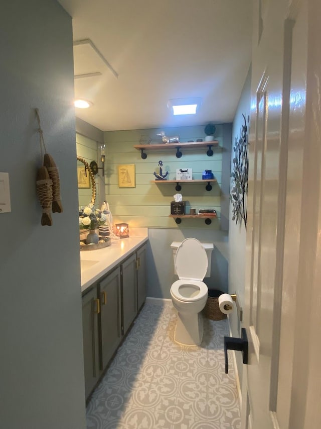 bathroom featuring tile patterned flooring, vanity, and toilet