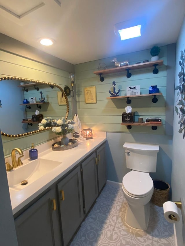 bathroom featuring tile patterned flooring, vanity, and toilet