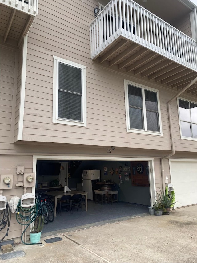 view of home's exterior featuring a garage and a balcony