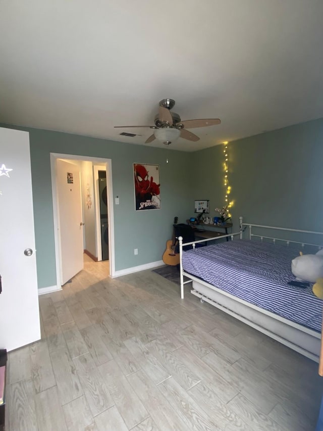 unfurnished bedroom featuring ceiling fan and light wood-type flooring