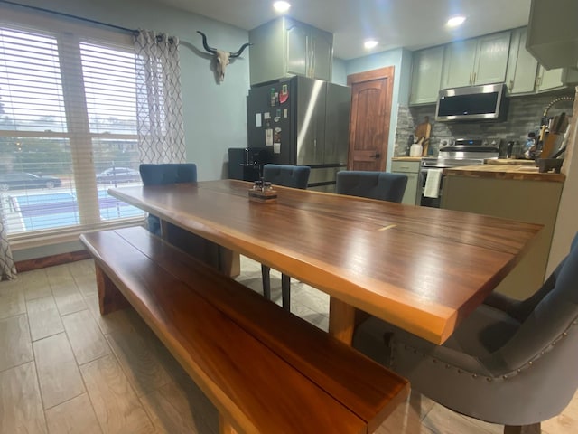 dining area featuring a wealth of natural light and light hardwood / wood-style floors