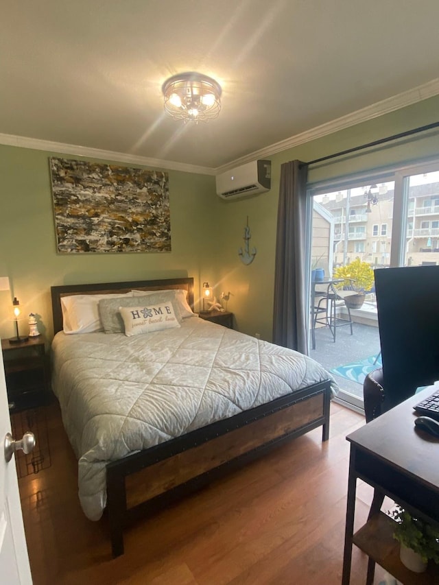 bedroom featuring hardwood / wood-style floors, ornamental molding, access to outside, and a wall mounted AC