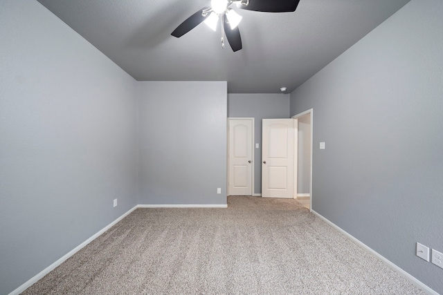 unfurnished room with ceiling fan and carpet flooring