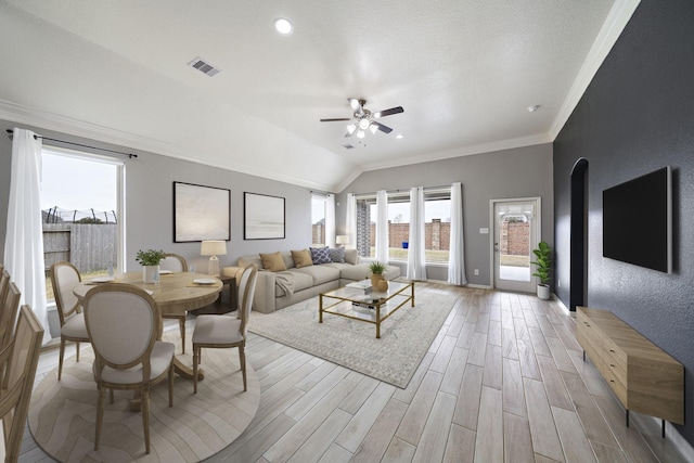 living room featuring ornamental molding, vaulted ceiling, and ceiling fan