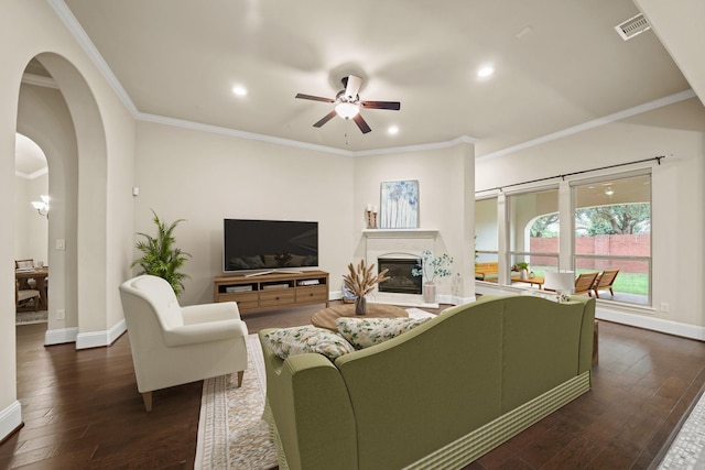 living room featuring crown molding, dark hardwood / wood-style floors, and ceiling fan