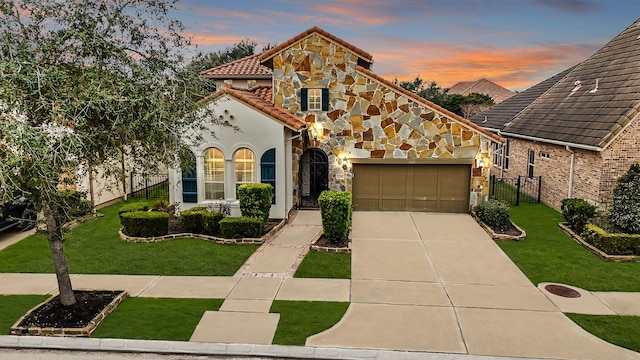 view of front of property with a garage and a lawn