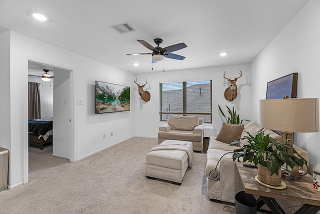 living room featuring light colored carpet and ceiling fan