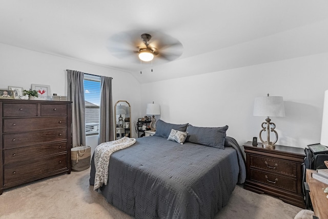 carpeted bedroom featuring ceiling fan and vaulted ceiling