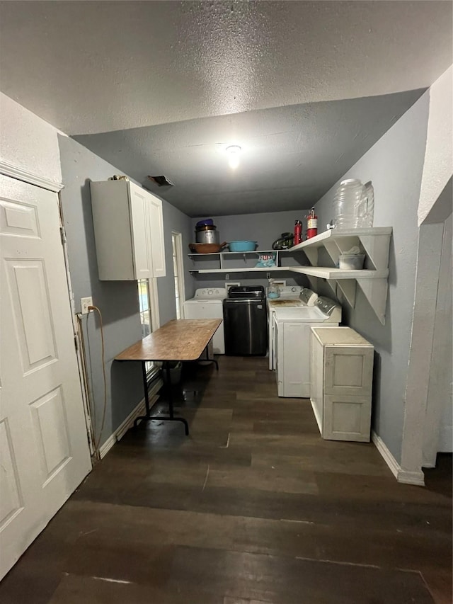 kitchen featuring white cabinetry, washer and dryer, a textured ceiling, and dark hardwood / wood-style flooring