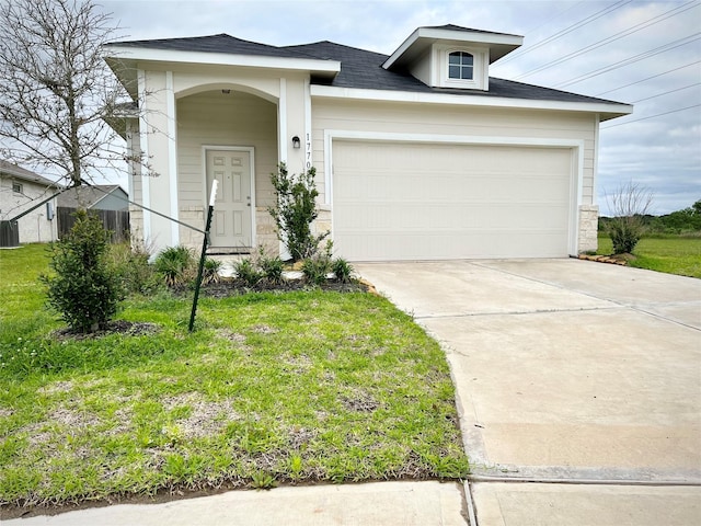 view of front of home featuring a garage and a front lawn