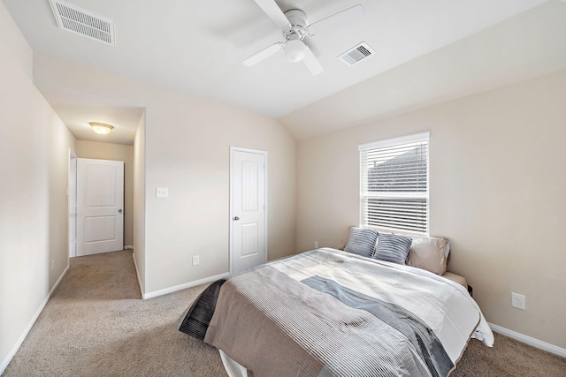 bedroom featuring lofted ceiling, light colored carpet, and ceiling fan