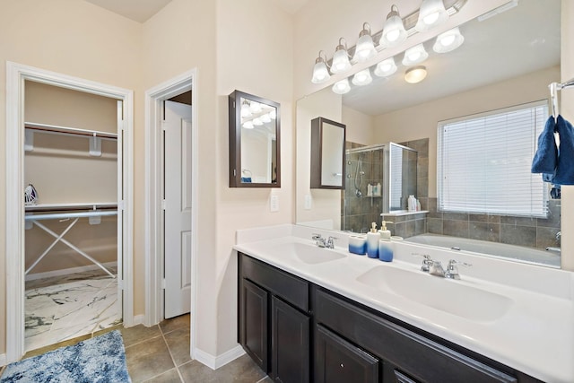 bathroom with tile patterned floors, vanity, and an enclosed shower